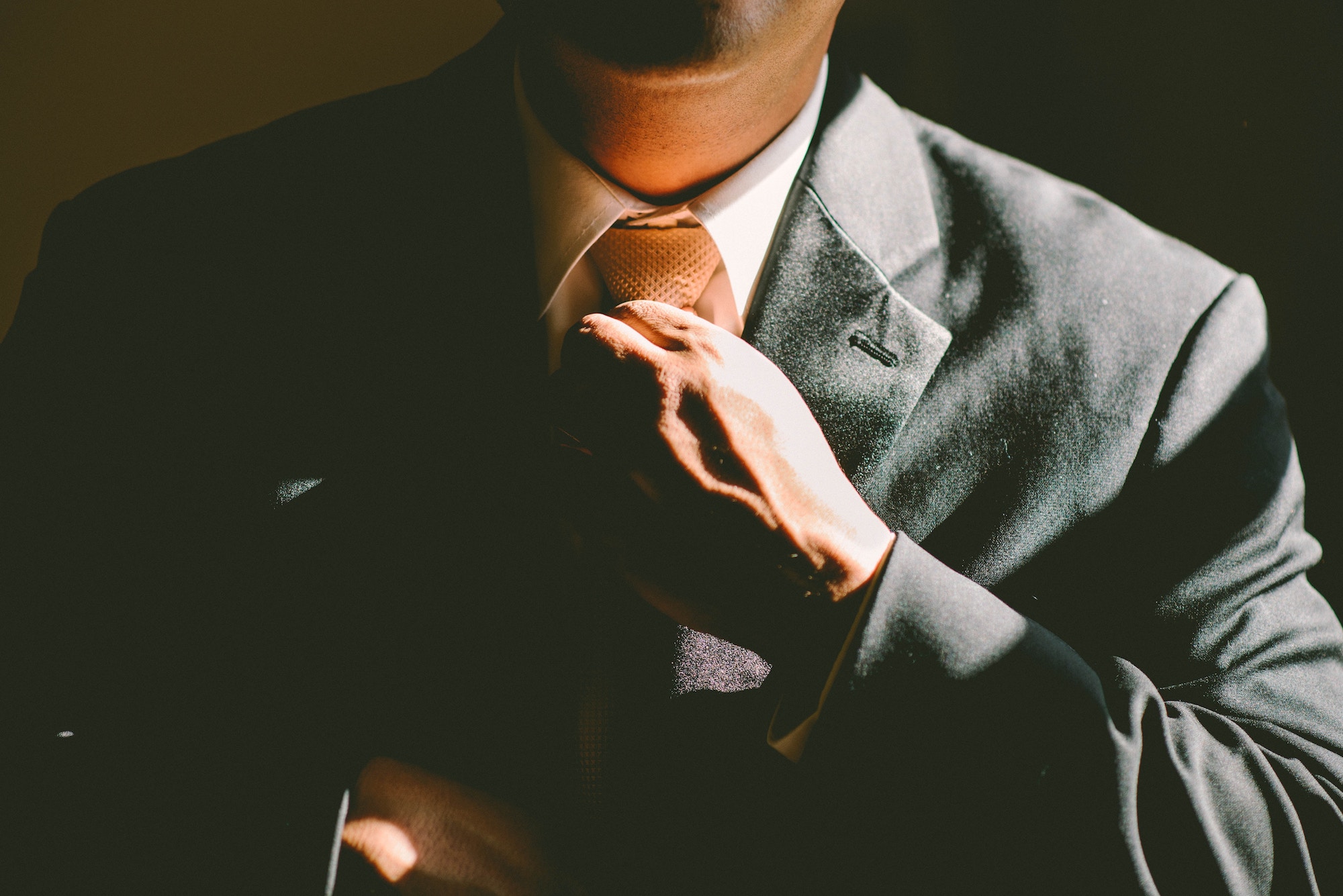 A businessman adjusting his tie for a consulting meeting